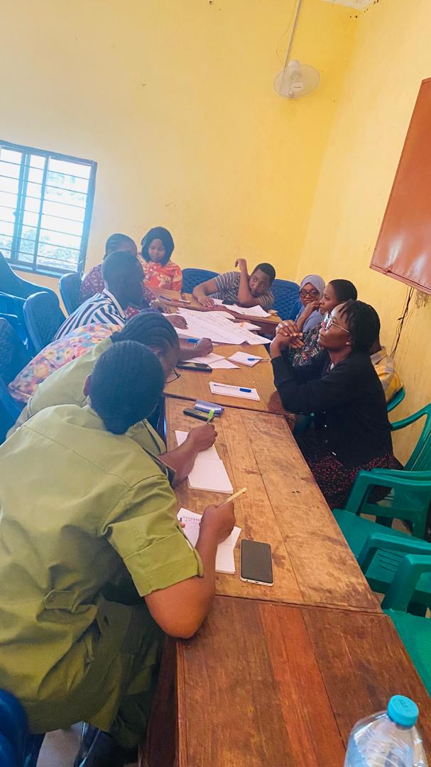 Participants discuss community issues around a table