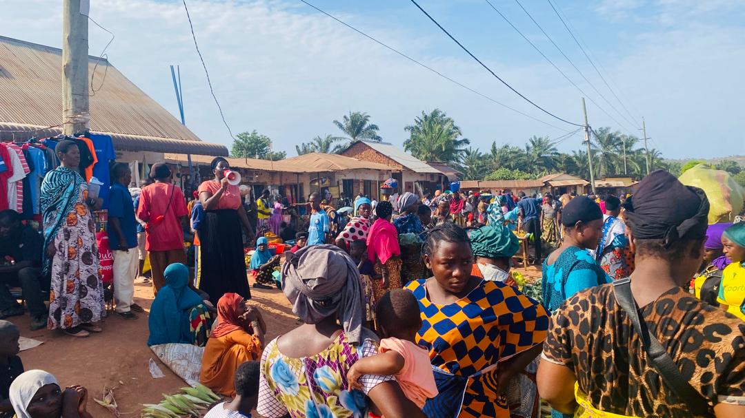 Women traders and families gather at a local market.